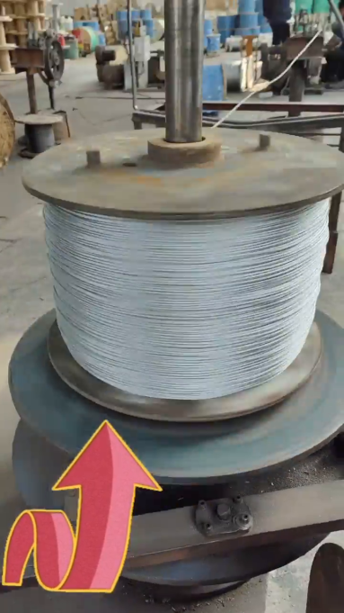 The galvanized steel wire rope is being produced, the worker is repacking them.