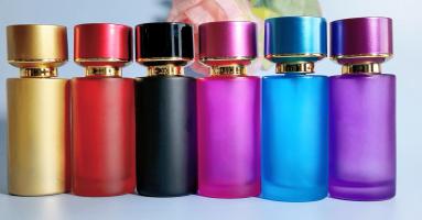 cylindrical perfume bottles of various colors